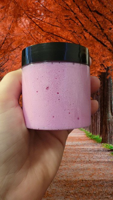 a person holding a pink and white cup 